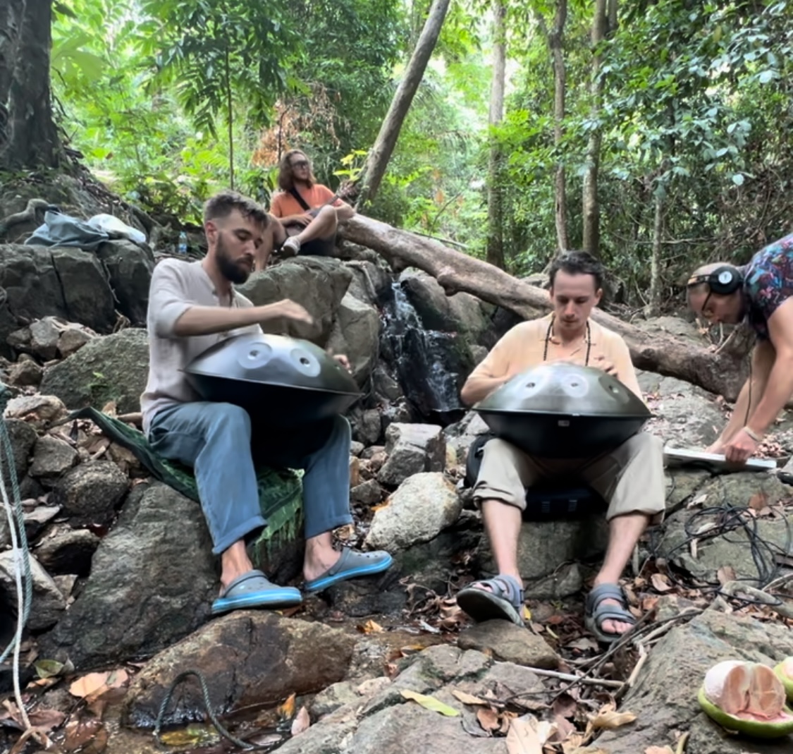 Photo of the waterfall and guys with instruments